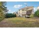 A manicured backyard with a lush lawn, mature trees, and a large patio, ideal for outdoor gatherings at 3423 Jamont Blvd, Alpharetta, GA 30022