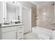 Clean and bright bathroom with granite counters, vanity, tub with shower, and stylish mirror at 3423 Jamont Blvd, Alpharetta, GA 30022