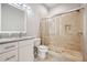 Modern bathroom featuring a glass shower, single sink vanity with granite countertop, and tiled walls at 3423 Jamont Blvd, Alpharetta, GA 30022