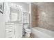 Well-lit bathroom with a tub, granite vanity, wall mirror, and stylish tiling at 3423 Jamont Blvd, Alpharetta, GA 30022