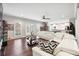 Expansive living room with a modern, white sofa and decorative pillows, with an adjacent kitchen view at 3423 Jamont Blvd, Alpharetta, GA 30022