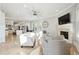Cozy living room with fireplace opens to a modern kitchen and dining area at 3423 Jamont Blvd, Alpharetta, GA 30022