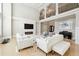 Living room with a white fireplace, hardwood floors, and elegant decor provides a welcoming space at 3423 Jamont Blvd, Alpharetta, GA 30022
