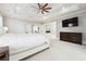 Spacious bedroom with coffered ceiling, ceiling fan, sitting area with fireplace, and large windows at 3423 Jamont Blvd, Alpharetta, GA 30022