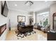Home office featuring a large desk, hardwood floors, a chandelier, and large windows for ample natural light at 3423 Jamont Blvd, Alpharetta, GA 30022