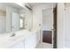 Bathroom featuring double sinks, white cabinets, and a shower/tub combo at 4045 Hillcrest View Ct, Suwanee, GA 30024