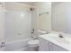 Full bathroom features shower over tub, white tile, and sink with a large mirror at 4045 Hillcrest View Ct, Suwanee, GA 30024