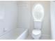 Bathroom featuring unique oval window and tiled shower and flooring at 4045 Hillcrest View Ct, Suwanee, GA 30024