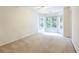 Neutral bedroom featuring carpet flooring and multiple large windows at 4045 Hillcrest View Ct, Suwanee, GA 30024