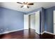 Bedroom featuring hardwood floors, blue painted walls, and a large closet at 4045 Hillcrest View Ct, Suwanee, GA 30024