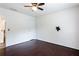 Spacious bedroom with hardwood floors, ceiling fan and a pre-installed TV mount at 4045 Hillcrest View Ct, Suwanee, GA 30024