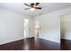 Bedroom with hardwood floors, ceiling fan, and access to an en-suite bathroom and closet at 4045 Hillcrest View Ct, Suwanee, GA 30024