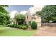 Well-maintained home featuring a two-car garage, basketball hoop, and manicured landscaping at 4045 Hillcrest View Ct, Suwanee, GA 30024