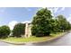 Exterior side view of home with a spacious yard, mature trees, and manicured shrubbery at 4045 Hillcrest View Ct, Suwanee, GA 30024