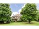 Charming brick home with lush green lawn and mature trees providing shade and curb appeal at 4045 Hillcrest View Ct, Suwanee, GA 30024