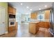 Open kitchen with wood cabinets, stainless steel appliances, and a center island at 4045 Hillcrest View Ct, Suwanee, GA 30024