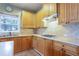 Close-up of kitchen counters and cabinets, a range, and a sink at 4045 Hillcrest View Ct, Suwanee, GA 30024