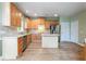 Well-lit kitchen featuring stainless steel appliances, an island, and lovely wood cabinets at 4045 Hillcrest View Ct, Suwanee, GA 30024