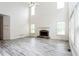 Bright living room features a fireplace, soaring ceilings, and large windows for natural light at 4045 Hillcrest View Ct, Suwanee, GA 30024