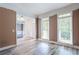 Bright, spacious room with natural light from large windows and stylish hardwood flooring at 4045 Hillcrest View Ct, Suwanee, GA 30024