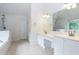 Bright main bathroom with double vanity, tiled floor, and separate shower and tub at 4045 Hillcrest View Ct, Suwanee, GA 30024