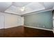 Spacious main bedroom with hardwood floors, tray ceiling, and natural light at 4045 Hillcrest View Ct, Suwanee, GA 30024