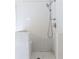 Close-up of a bright shower with a showerhead and tiled walls at 4045 Hillcrest View Ct, Suwanee, GA 30024