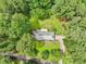 A home surrounded by lush greenery and mature trees in a peaceful, serene setting from an aerial view at 415 Haven Ln, Marietta, GA 30066