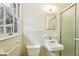 Cozy bathroom with tiled walls, sink, and glass shower at 415 Haven Ln, Marietta, GA 30066