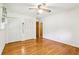 Bright bedroom features hardwood floors, ceiling fan, and double closets at 415 Haven Ln, Marietta, GA 30066