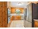 Well-lit kitchen featuring wood cabinets, stainless steel appliances, and tile flooring at 415 Haven Ln, Marietta, GA 30066