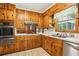 Well-maintained kitchen with wood cabinets, stainless steel appliances, and tile flooring at 415 Haven Ln, Marietta, GA 30066