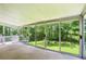 Enclosed sunroom with floor-to-ceiling windows with wooded view at 415 Haven Ln, Marietta, GA 30066