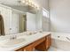 Bright bathroom with double sinks, vanity, bathtub, and ample counter space at 4284 Cabretta Se Dr, Smyrna, GA 30080