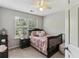 Cozy bedroom with a decorative bed, dresser, and lots of natural light at 4284 Cabretta Se Dr, Smyrna, GA 30080