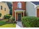 Inviting front entrance with a black door, brick facade, and lush green landscaping at 4284 Cabretta Se Dr, Smyrna, GA 30080