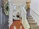 Open living room with high ceilings, fireplace, hardwood floors, and staircase at 4284 Cabretta Se Dr, Smyrna, GA 30080