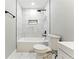 Bathroom featuring a shower with marble-style tiling, black fixtures, and built-in tub at 124 Sims Dr, Hiram, GA 30141