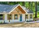 Charming home with symmetrical facade, shutters, concrete pathway and gabled roof at 124 Sims Dr, Hiram, GA 30141