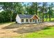 Charming single-story home with a white exterior, dark shutters, and a well-manicured lawn at 124 Sims Dr, Hiram, GA 30141