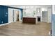 Open-concept kitchen with island, modern pendant lights, and stainless steel appliances at 124 Sims Dr, Hiram, GA 30141