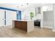 Modern kitchen with island, stainless steel appliances, white cabinets, and custom hood at 124 Sims Dr, Hiram, GA 30141