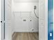 Functional laundry room with folding closet and shelving for optimal storage at 124 Sims Dr, Hiram, GA 30141