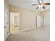 Carpeted bedroom with a ceiling fan and adjoining bathroom providing a comfortable living space at 189 Privet Cir, Suwanee, GA 30024
