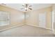 Comfortable carpeted bedroom providing natural light with a ceiling fan adding an extra feature at 189 Privet Cir, Suwanee, GA 30024