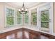 A breakfast nook features bright windows and wood floors at 189 Privet Cir, Suwanee, GA 30024
