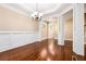 Dining room featuring hardwood floors, decorative chandelier, and large pillars at 189 Privet Cir, Suwanee, GA 30024