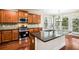 Gourmet kitchen with stainless steel appliances, granite countertops, and custom cabinetry at 189 Privet Cir, Suwanee, GA 30024