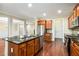 Kitchen showcases a central island with granite countertop and stainless steel appliances and fixtures at 189 Privet Cir, Suwanee, GA 30024
