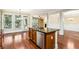 A kitchen with an island, wood cabinets, stainless steel dishwasher, sink and faucet at 189 Privet Cir, Suwanee, GA 30024